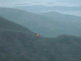 Soaring against the silhouette of Mariner Cove (3968127 bytes)